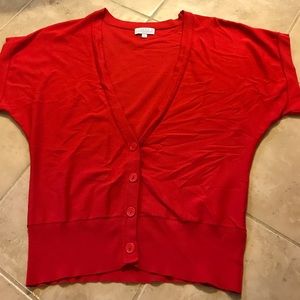 Red short sleeved cardigan.